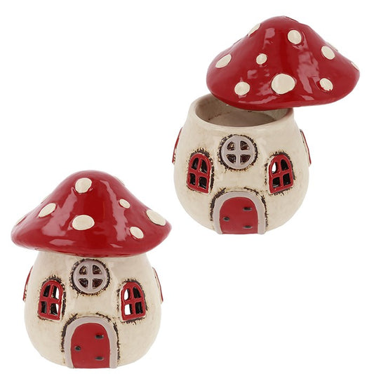 Ooh, my lovely—have a peek into the heart of the enchanted forest with this Village Pottery Toadstool House Warmer. Handcrafted by skilled potion-makers (or rather, artisans), this ceramic wonder weaves whimsy and warmth in equal measure.
With its ruby-red cap and storybook windows, this toadstool cottage looks plucked from a faerie glade. Use it as a wax melt burner, oil diffuser, or simply to grace your altar or shelf with woodland magic. The mushroom top lifts to reveal a secret well—perfect for your fa