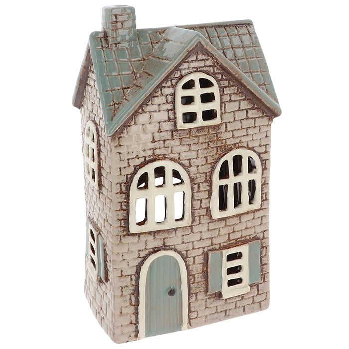 step into a realm of hearth and home with this Village Pottery Brick House Grey Tealight Holder—a bewitching piece of ceramic magic conjured just for your sacred space. Hand-shaped with care and cloaked in dusky grey, each little house is one-of-a-kind, its surface whispering secrets of ancient stone cottages nestled deep within the misty moors.
Cast your tealight spell within its hollow back, and behold! A gentle, golden glow flickers through its windows like a lantern in the fog, summoning warmth, peace,