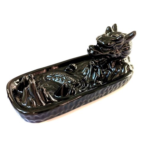  
Summon mystical energy into your sacred space with this striking Dragon in Mountain Backflow Incense Burner. Handcrafted with intricate detail, the fierce dragon coils around a craggy mountain peak, guarding the cascading waterfall of aromatic smoke. When paired with backflow incense cones, the smoke flows downward like enchanted mist, pooling at the base in a magical display.
Ideal for meditation, spellwork, or simply creating a calming atmosphere, this incense burner is both a functional tool and