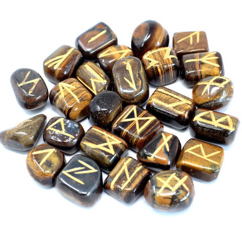 Unlock the ancient art of divination with this handcrafted Tiger Eye Rune Set, featuring 25 stones (24 engraved with rune symbols, 1 blank) nestled in a protective pouch. Each rune is carved from Tiger Eye, a powerful semi-precious stone known for its grounding, protective, and confidence-boosting properties. This shimmering golden-brown stone enhances mental clarity, helps with decision-making, and is often used to ward off negative energy. Ideal for spiritual seekers, beginners, or seasoned rune readers,