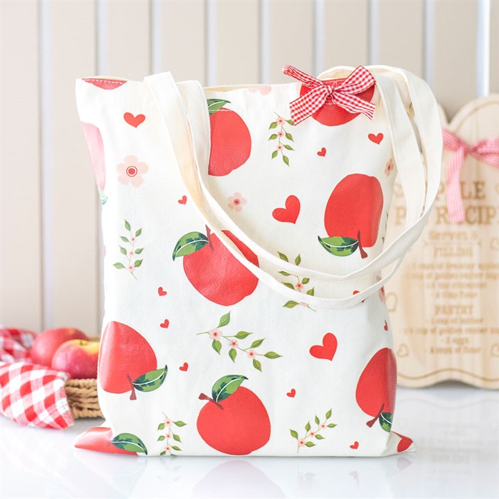 White tote bag with red apple pattern on a white background
