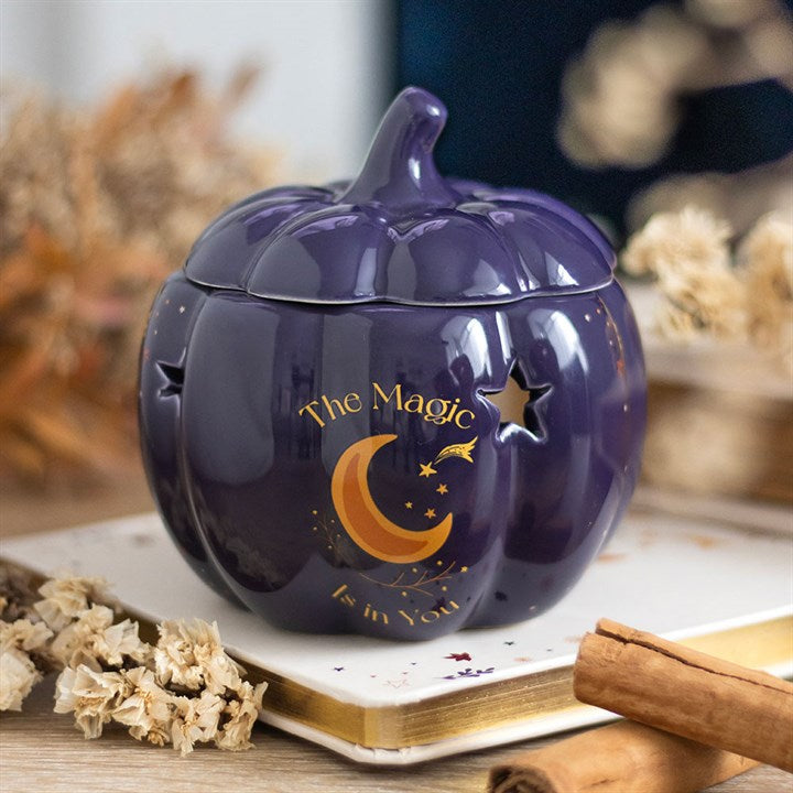 Embrace the enchanting glow of autumn with The Magic Is in You Pumpkin Oil Burner. Crafted from midnight-blue ceramic, this mystical pumpkin-shaped burner is adorned with shimmering golden stars and a crescent moon, inviting a touch of celestial magic into your space. Perfect for those who cherish the changing seasons and the warm, inviting scents that come with them, it transforms any room into a cozy sanctuary. Designed for use with fragrance oils diluted in water, it gently releases your chosen aromas, w