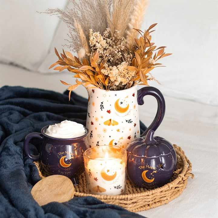 Embrace the enchanting glow of autumn with The Magic Is in You Pumpkin Oil Burner. Crafted from midnight-blue ceramic, this mystical pumpkin-shaped burner is adorned with shimmering golden stars and a crescent moon, inviting a touch of celestial magic into your space. Perfect for those who cherish the changing seasons and the warm, inviting scents that come with them, it transforms any room into a cozy sanctuary. Designed for use with fragrance oils diluted in water, it gently releases your chosen aromas, w