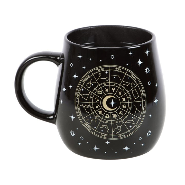 Infuse your morning ritual with cosmic enchantment using this mystical heat-sensitive mug. As warmth fills the 500ml black ceramic vessel, a radiant gold Astrology Wheel emerges, encircled by shimmering stars. Dishwasher safe for easy cleansing, but keep it away from the microwave to preserve its magic.