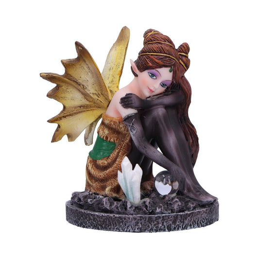 Meet Amber, a captivating fairy figurine nestled with her knees snug under her chin, overseeing a glass ball and crystals, embodying an autumnal theme.