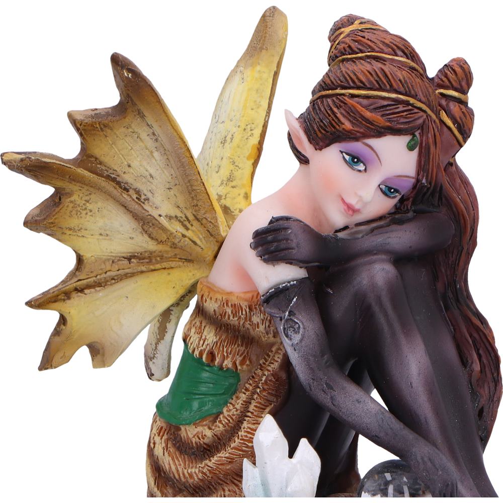 Fairy figurine with large wings and detailed hair on a white background