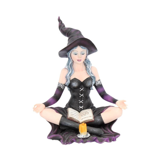 This stunning figurine features Aradia, wearing a black corseted dress, sitting crossed legged, cradling her grimoire with her legs, while staring into the burning flame of a candle.