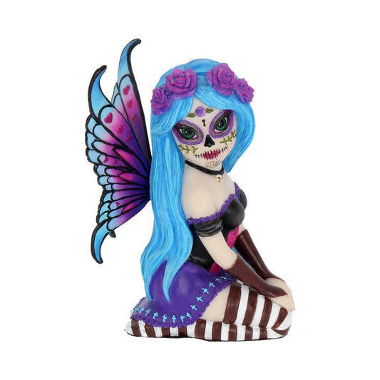This striking, naughty little Sugar Skull fairy is called Azula. She is innocently kneeling on her striped legs. Wearing a black corseted dress that has a purple skirt, fringed with little blue crosses. In her hair she wears purple roses that contrast perfectly with her bright blue hair, framing her lovely, decorated face.