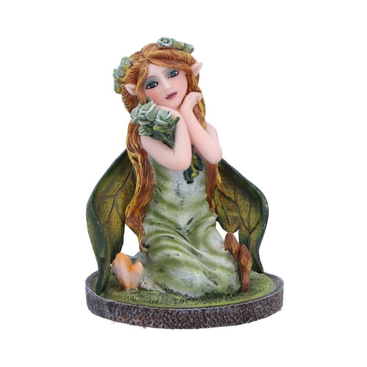 Clover, the enchanting fairy figurine embracing flowers while crystals and mushrooms emerge from the grass around her knees. She’s a perfect addition to any fairy collection.