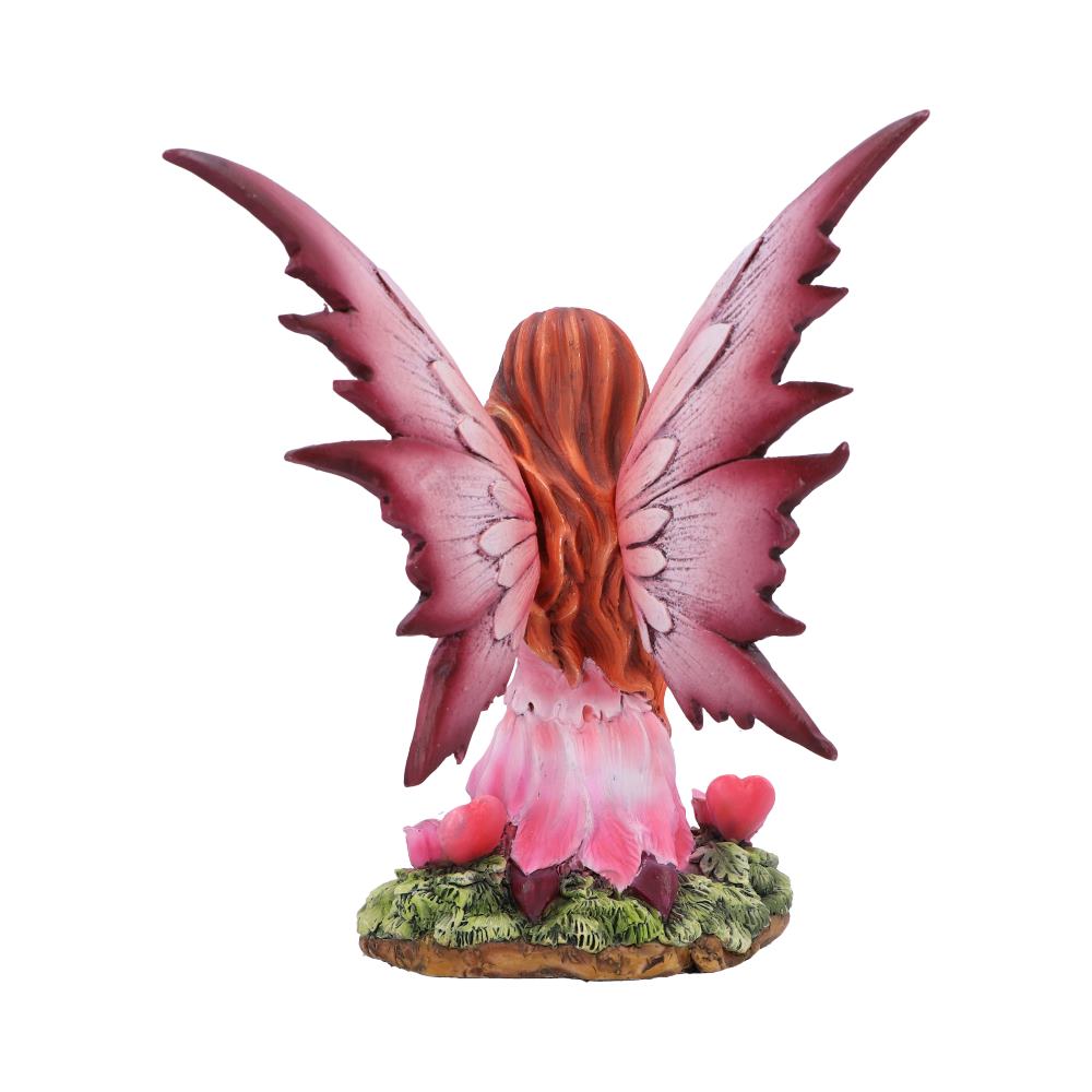 Fairy figurine with pink wings and body on a white background
