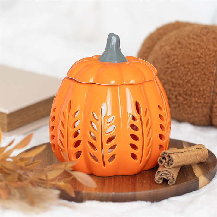 Embrace the spirit of autumn with this enchanting orange pumpkin oil burner and wax warmer, adorned with intricate cut-out designs that cast a warm, inviting glow. Ideal for melting seasonal wax melts or fragrant oils, it weaves a cozy, magical ambiance throughout your space. Remember to lift the lid as you summon the comforting scents of the harvest season.