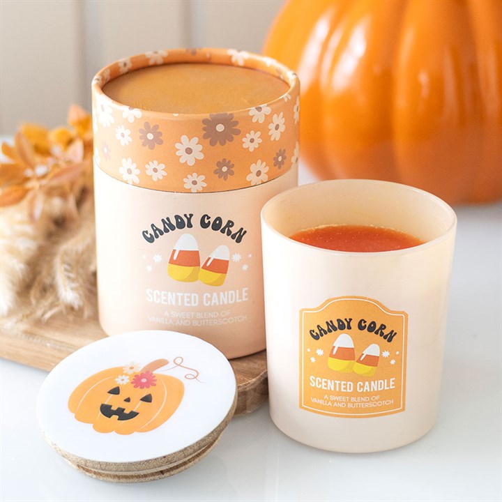 Embrace the enchanting spirit of autumn with this Candy Corn Vanilla and Butterscotch Candle. Infused with the sweet, nostalgic scents of candy corn, creamy vanilla, and rich butterscotch, it weaves a warm, magical aura perfect for spellbinding Halloween nights or quiet, cozy evenings. Housed in a glass holder adorned with pumpkin and candy corn motifs and sealed with a wooden lid, this candle invites a touch of mystical charm to your space. Presented in a matching cylinder box, it’s a bewitching gift for t