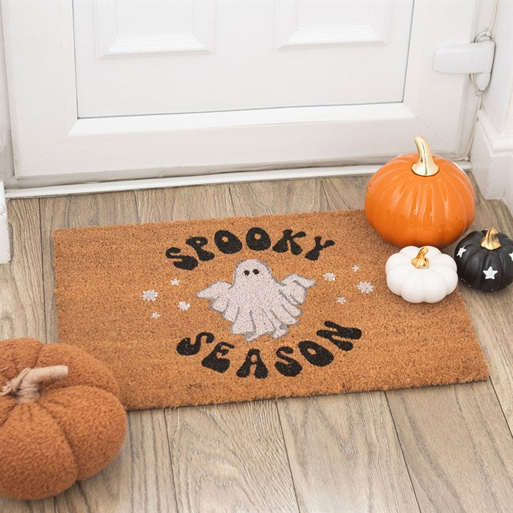Embrace the enchanting aura of autumn with our Natural Spooky Season Ghost Doormat, crafted from natural coir to welcome your guests with a touch of mystical charm. This whimsical mat showcases a groovy floating ghost, inviting playful spirits to your doorstep during Halloween and the crisp fall season. Its natural fibers offer durability while adding an earthy texture to your entryway. Please note, the design may gently fade under harsh weather conditions, so it is best suited for sheltered or indoor space