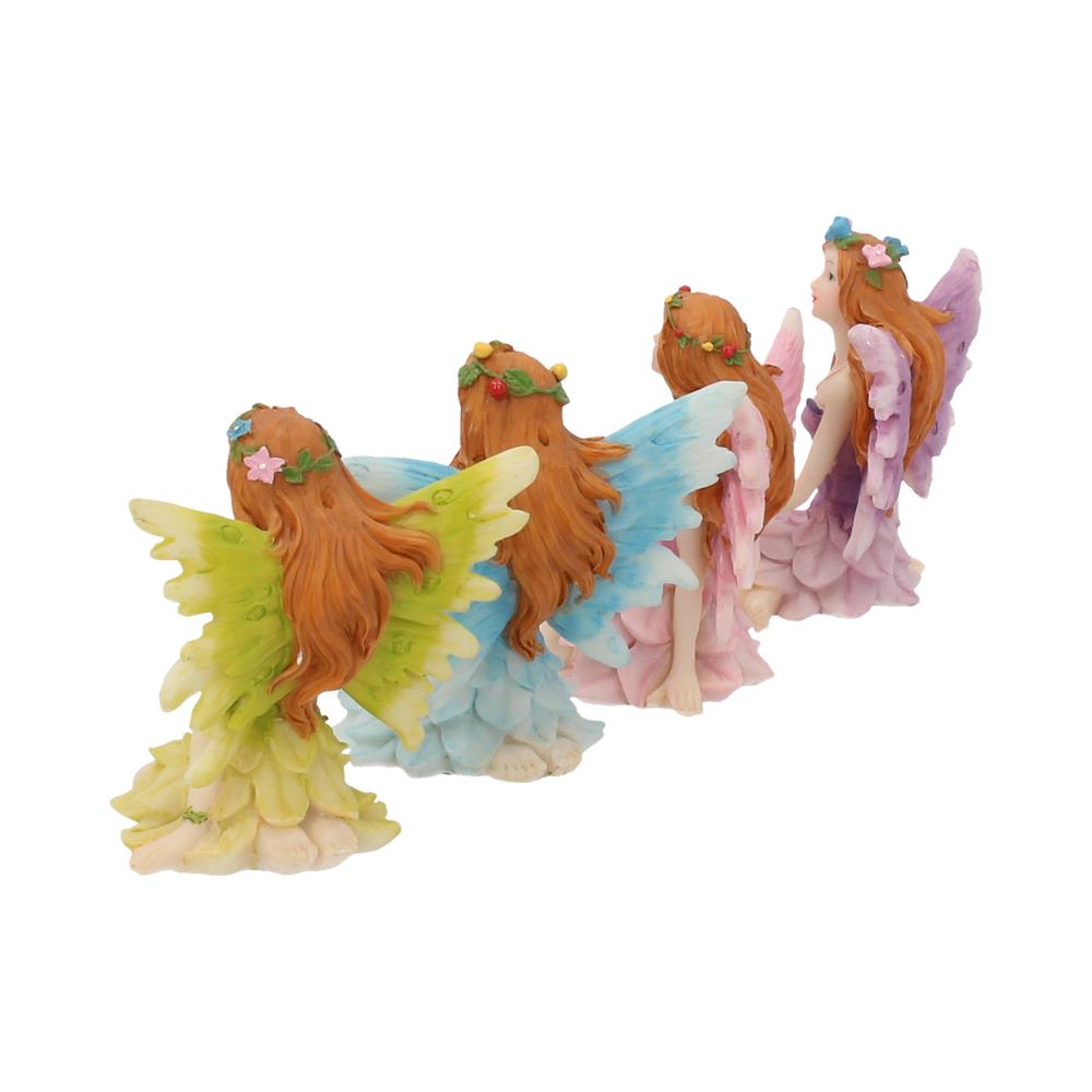 Set of four fairy figurines with colourful wings on a white background