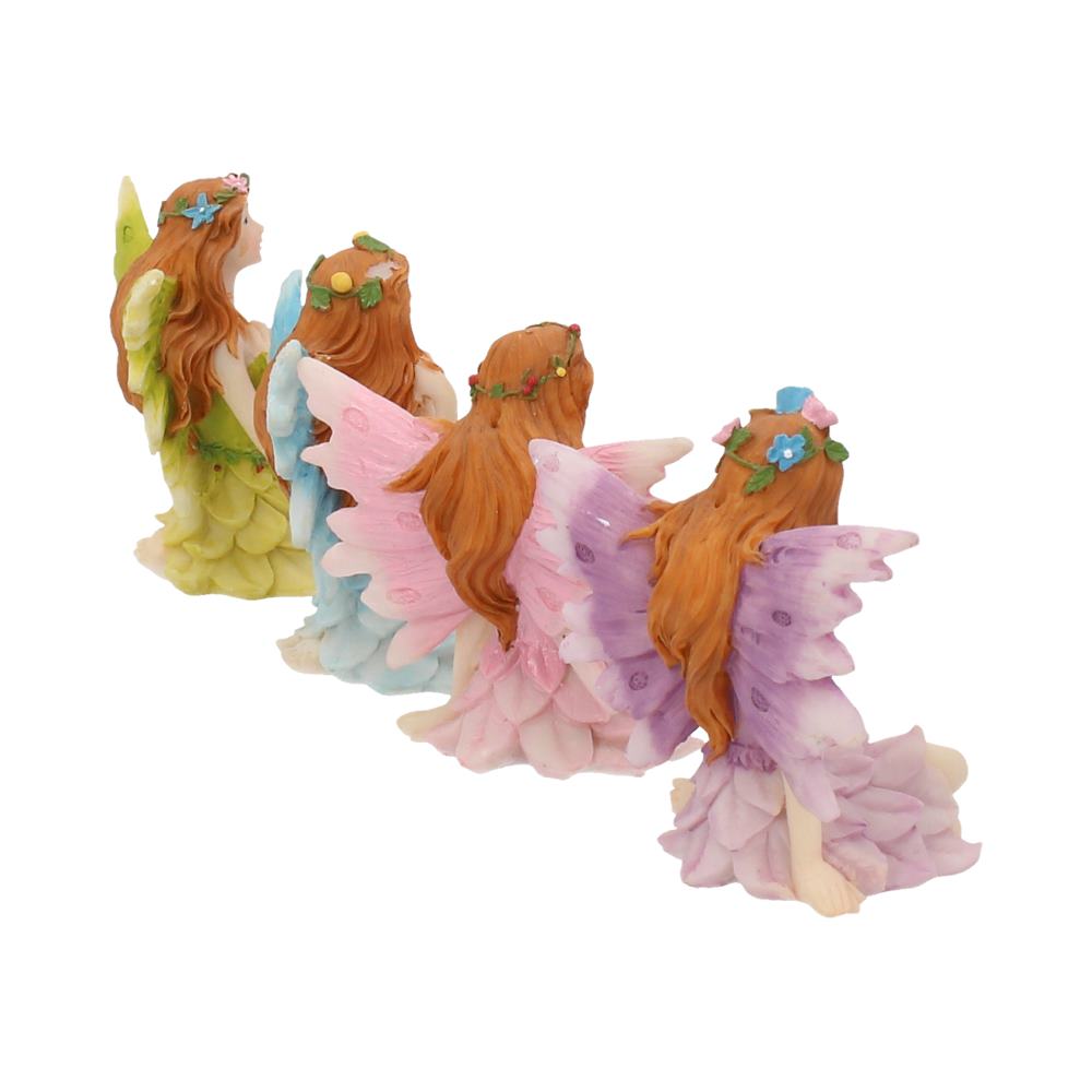 Set of four fairy figurines with colourful wings on a white background