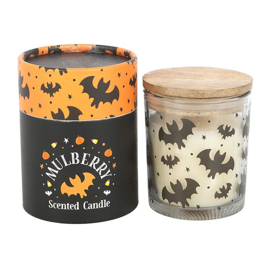 Set the mood with this batty candle, featuring a mulberry scent that fills the home with a warm and inviting aroma. Housed in a printed glass jar with a natural wooden lid, this candle makes a great addition to Halloween décor. Approximately 28-hour burn time. Made from paraffin wax. Never leave a lit candle unattended.
