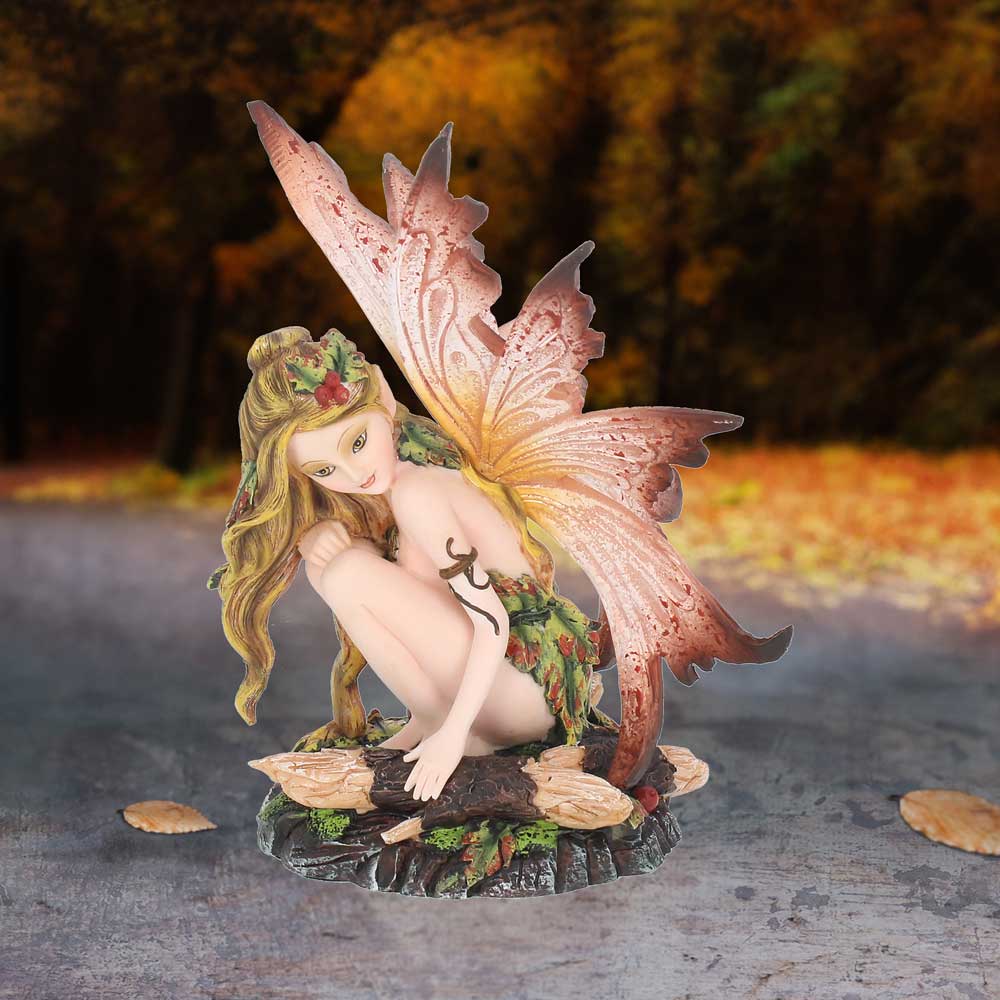 Fairy figurine with colorful wings on a natural background