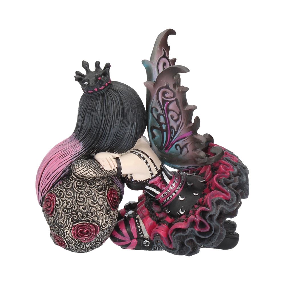 Decorative figurine of a woman with black hair and a creature with pink and purple patterns on a white background.