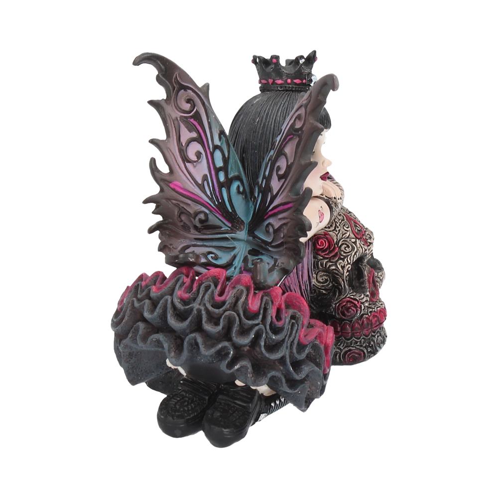 Decorative figurine of a fairy with intricate designs on a white background