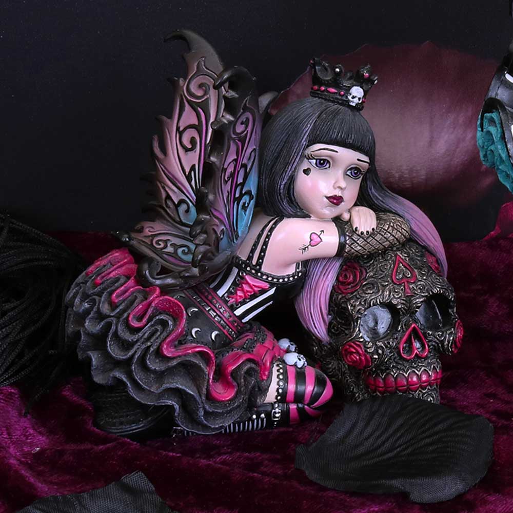 Gothic-style figurine with decorative elements on a dark background