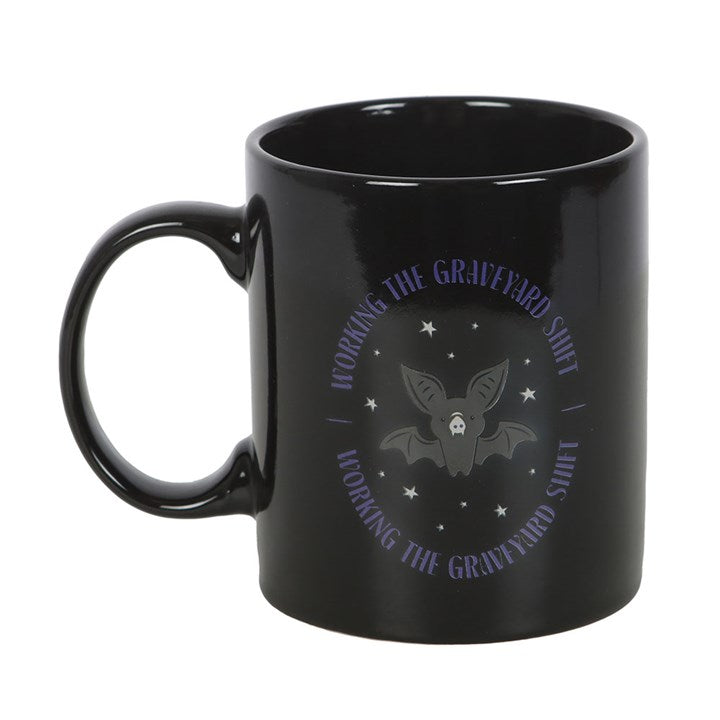 “Through the witching hour, the bat keeps watch.”
The Graveyard Shift Bat Mug is a dark delight for night owls, witches, and lovers of the eerie. With a generous 450ml capacity, this black ceramic mug is adorned with a hauntingly fun bat design — a familiar of the night, a creature of mystery, and a symbol of transformation. Microwave and dishwasher safe, it is perfect for strong brews that fuel your vigils, studies, or midnight rituals.
In folklore, bats are tied to the unseen realms, able to navigate thr