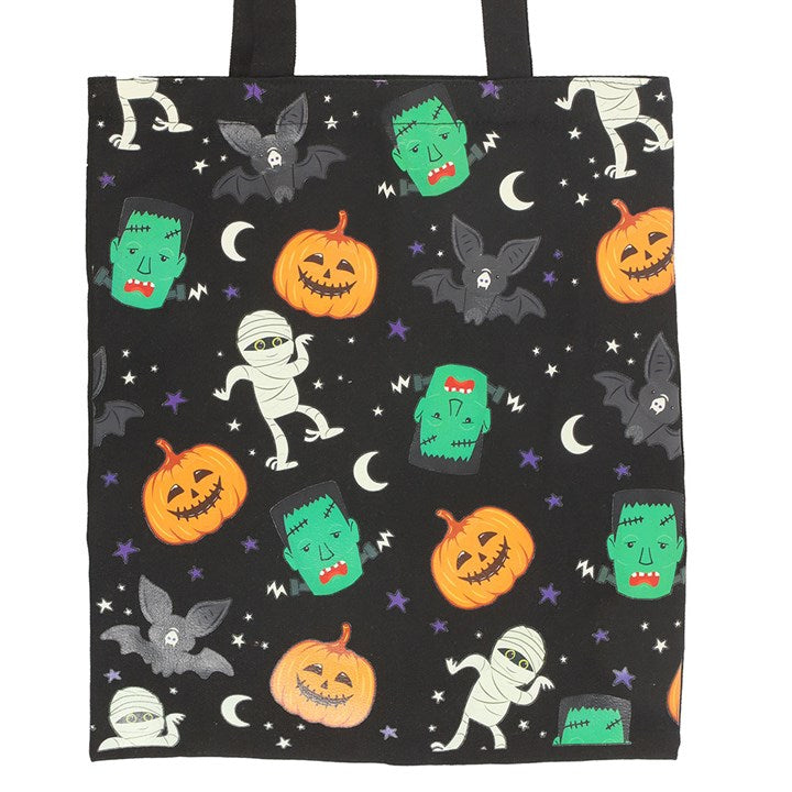 Black tote bag with Halloween-themed design featuring pumpkins, ghosts, and bats on a white background.