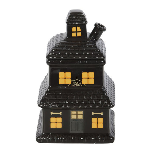 Add a touch of haunted elegance to your home with this haunted house oil burner and wax warmer. Suitable for both wax melts and diluted fragrance oils, this spooky piece creates a warm glow while diffusing your favourite eerie aromas. Simply place a tealight in the holder, remove the lid while in use, and enjoy. Always allow to cool before handling.