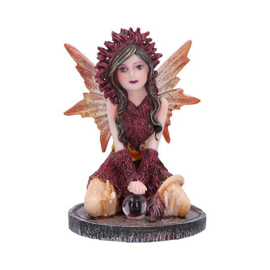 Meet Poppy, a captivating fairy figurine perched forward on her knees, hands resting delicately on a glass ball adorned with crystals. Her design, featuring vibrant orange and red hues and intricate wings, resonates with natural beauty.