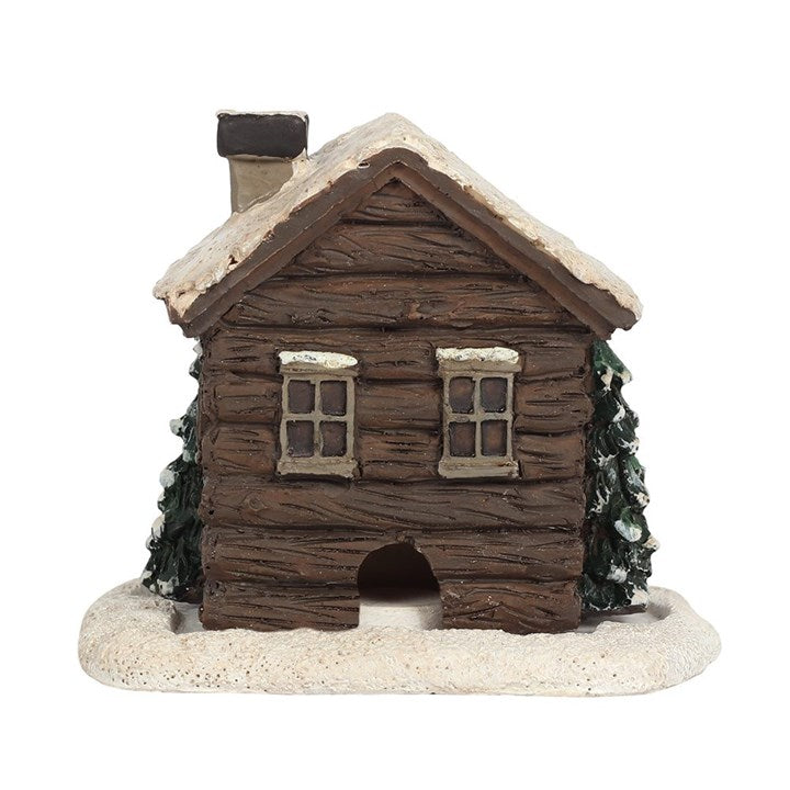 This enchanting log cabin incense cone burner conjures the perfect ambiance for a mystical winter evening. Light the cone, and watch as smoke gently curls from the chimney, mimicking a cozy fire flickering inside. Designed exclusively for incense cones, some may take up to 10 minutes to release their full smoky magic. Dimensions: H10cm x W10.5cm x D7.5cm. Packaged: H11.5cm x W11.3cm x D7.5cm. Embrace the warmth of this tiny hearth in your sacred space.