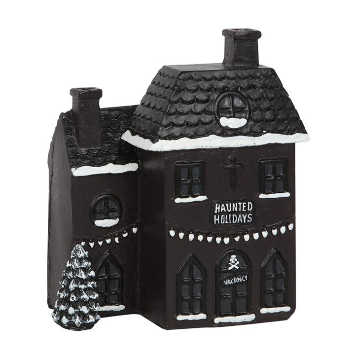 Step into a realm where shadows dance and spirits linger with this haunted holiday house incense cone burner. This eerie black abode offers a bewitching twist on festive décor, creating a perfect gothic sanctuary for your incense cones. Place a cone inside and watch as ghostly smoke curls from its twin chimneys, casting an enchanting spell. Dimensions: H14cm x W12cm x D7cm; Packaged: H17cm x W15cm x D9cm. Embrace the mystical charm of your haunted holiday retreat.