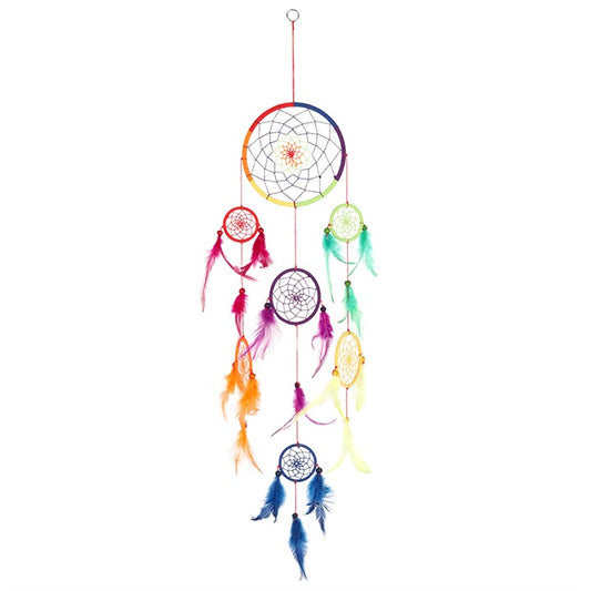Among the Ojibwe people, the dreamcatcher was first woven as a sacred web of protection. Hung above the cradle or the bed, it was said to let good dreams pass gently through the center while trapping harmful spirits in its strands, where they dissolve with the morning sun.
This 90cm Multi Rainbow Dreamcatcher carries the spirit of many colors, each thread symbolizing harmony, hope, and the circle of life. The rainbow is honored in many traditions as a bridge between earth and sky, a promise of renewal, and