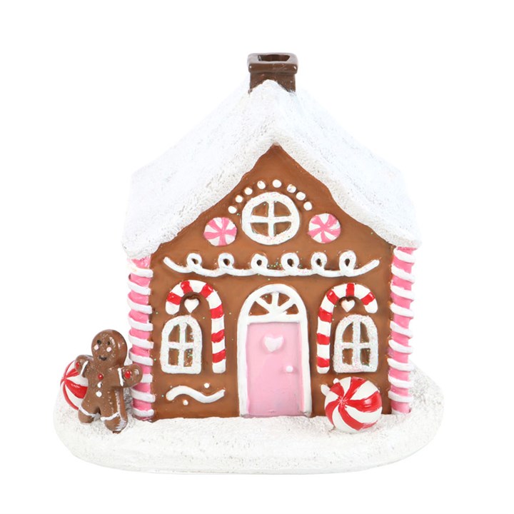 Step into an enchanted Christmas tale with this charming pink gingerbread house incense cone burner, adorned with delightful candy cane and sugar frosting accents. Light a cone inside, and watch as mystical smoke curls from the chimney, casting a spell of festive wonder. When unlit, it transforms into a captivating ornament, destined to be a cherished part of your holiday altar for many seasons to come