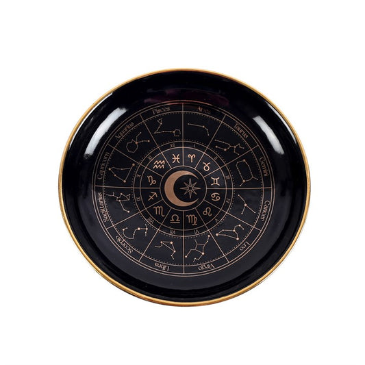This enchanting black trinket dish features a finely detailed astrology wheel in shimmering gold, radiating an aura of celestial elegance. Perfect for safeguarding your precious charms and jewelry, it adds a magical accent to any space adorned with cosmic-inspired decor.
