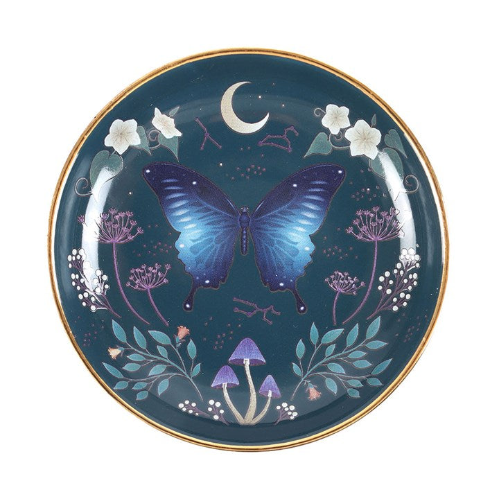 This captivating trinket dish showcases a mesmerizing midnight moth motif in deep blues, echoing the mysteries of the night sky. Adorned with intricate floral accents and shimmering gold trim, it promises to be a cherished talisman and a bewitching addition to your sacred space.