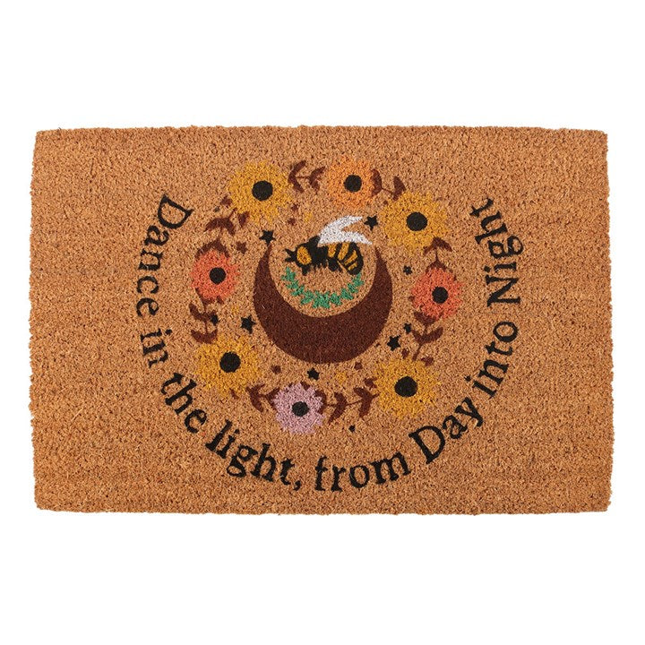 Welcome the season with this natural Summer Solstice-inspired coir doormat. Featuring a crescent moon. bee, and sunflower design with the uplifting text "Dance in the light from day into night", this doormat adds a rustic touch to any entryway while celebrating the vibrant energy of the solstice. The perfect doormat to only display indoors or under sheltered porches during the warmer months. Please note that the printed design may fade when left outside in extreme weather.
