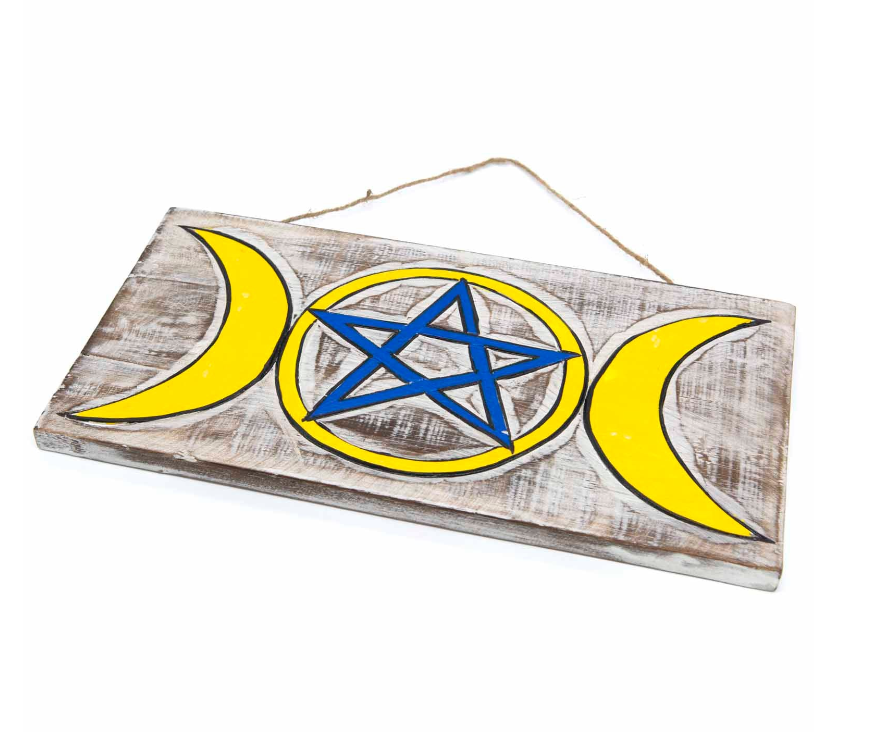 Embrace the sacred energies of the Triple Goddess with this enchanting wall plaque, featuring a striking white wash background that beautifully highlights the vibrant hand-painted design. The intertwined symbols of the Triple Goddess and pentacle invite protection, balance, and spiritual connection into your space. Crafted with care and Fairtrade certified from Indonesia, this mystical piece carries both meaning and ethical craftsmanship. Measuring approximately 39cm by 20cm, it comes ready to hang with thi