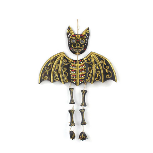 Ahhh, little mortal, ye gaze upon the Candy Skull Bat—a creature of whimsy and woe, conjured from solid wood and bewitched with colours most vivid. Hand-carved in the shadowy workshops of Indonesia, each bat bears sacred markings inspired by the ancient calaveras and calacas of Mexican tradition.