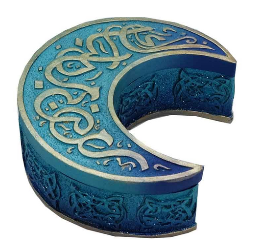 In the cradle of the moon, your treasures shall rest. This Blue Crescent Moon Trinket Box is a spell of beauty and purpose, crafted from sturdy cold-cast resin and shaped in the sacred curve of the waxing moon. The lid, adorned with curling silver ribbons upon a deep celestial blue, is framed with a matching border—a portal to the mysteries within.