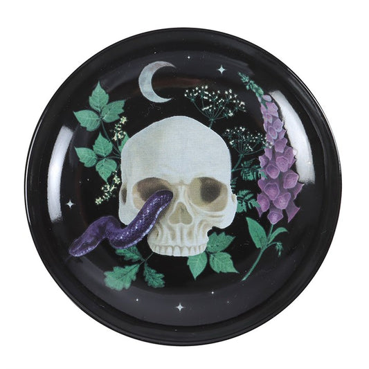 Store your precious charms and keepsakes in this captivating ceramic dish adorned with a skull and serpent design. Ideal for holding jewellery, keys, or tiny treasures, it adds an enchanting touch to any vanity or nightstand. A bewitching gift for lovers of gothic and mystical décor.
