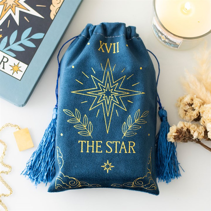 A soft blue velvet drawstring bag featuring a gold printed The Star tarot card design. Ideal for storing tarot decks, crystals, or small accessories.