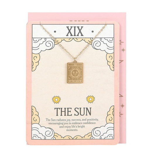 This gold-toned pendant necklace features The Sun tarot card design, symbolising joy, success, and positivity. Presented on a beautifully illustrated greeting card, it makes a thoughtful gift for tarot lovers and celebrating life’s precious moments.