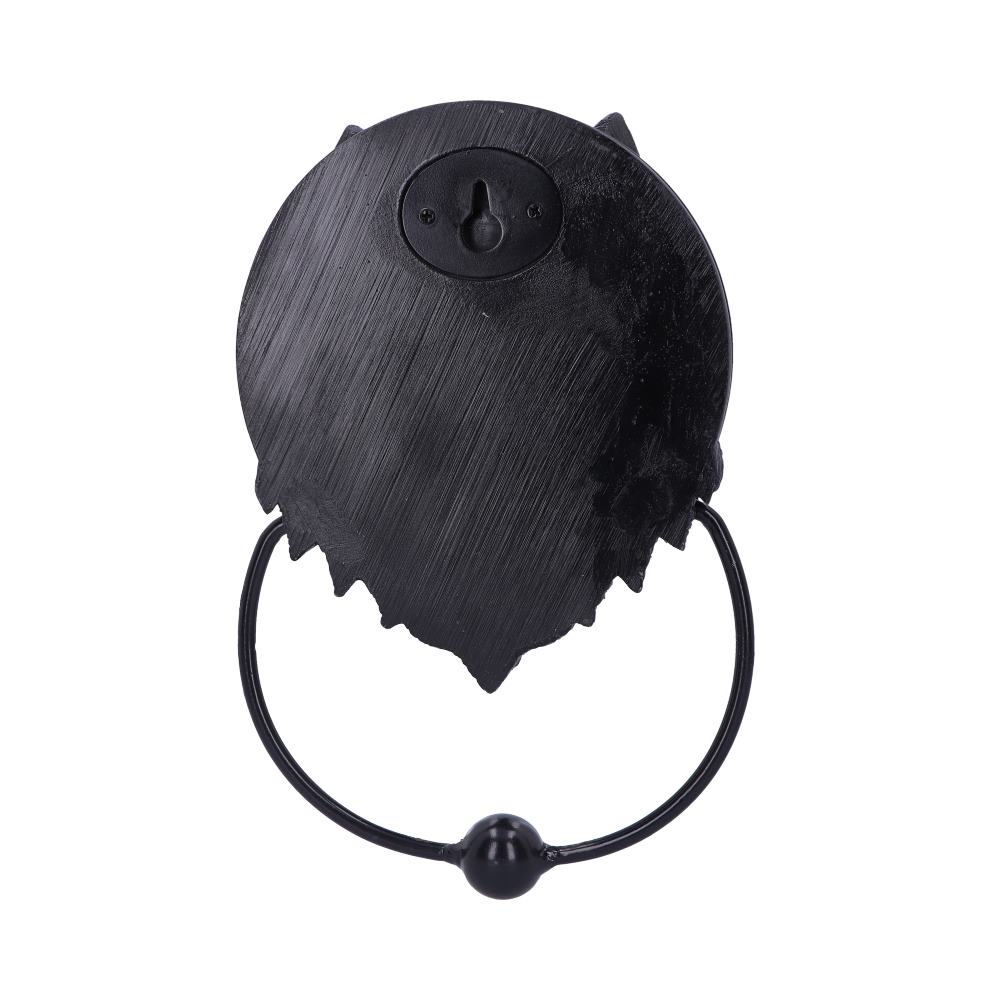 Add a touch of mystical charm to your entrance with this striking Wolf Moon door knocker. This beautifully crafted piece is cast in high-quality resin and expertly hand-painted.  The wolf's watchful eyes and detailed design create a captivating focal point, adding character to your home's exterior. The solid metal ring provides a clear, resonant knock.