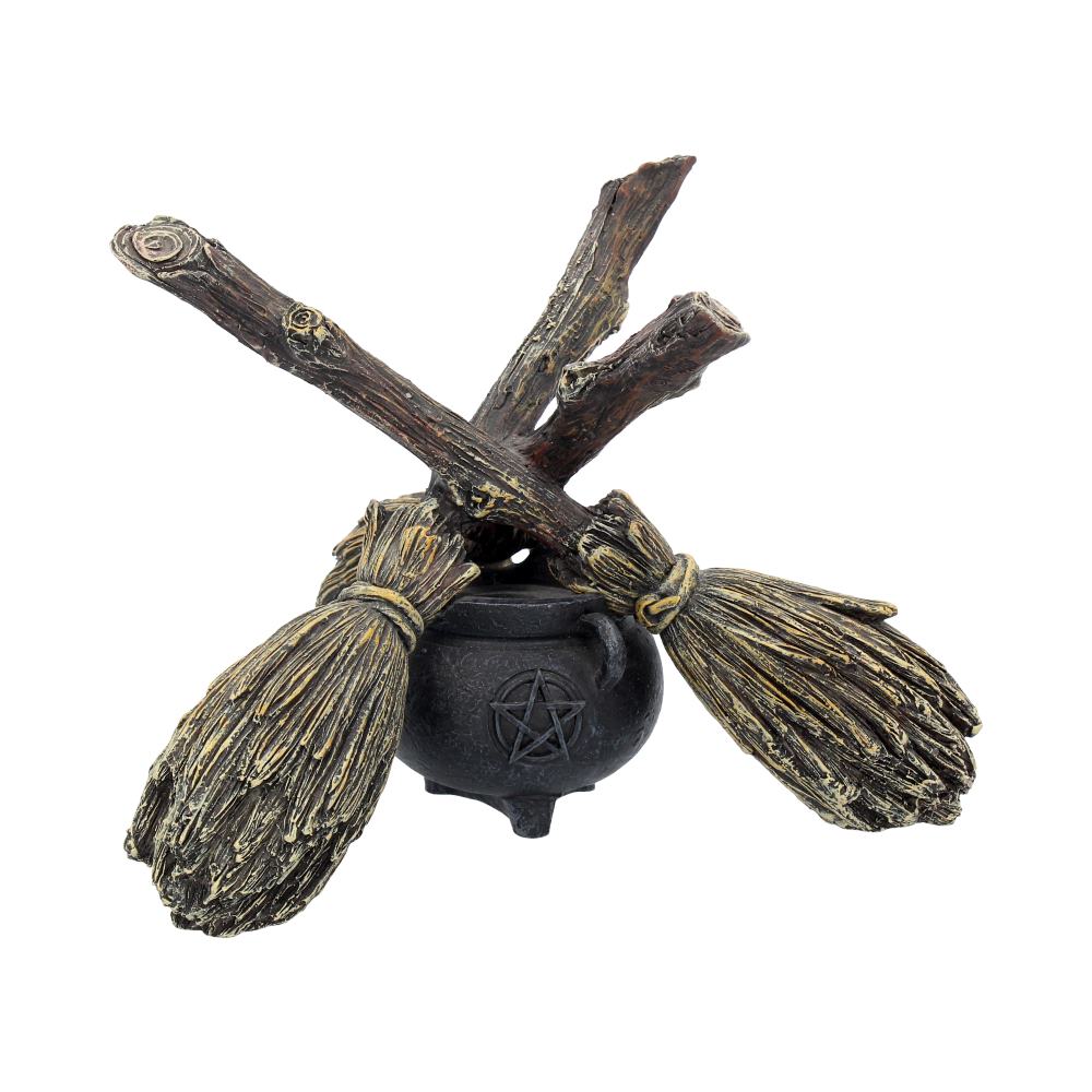 Decorative item with two brooms and a black cauldron on a white background