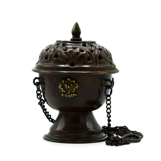 Invite serenity and sacred energy into your space with the Copper Tibetan Incense Burner – Classic Hanging. Handcrafted in India, this elegant hanging burner transforms incense into a flowing ritual, filling your home with calming fragrance and timeless spiritual presence.
Made from durable copper, the burner features an intricate design that speaks to centuries of Tibetan artistry. The verdigris finish evokes an aged, antique charm, while the hanging chain allows smoke to cascade freely, creating a mesmer