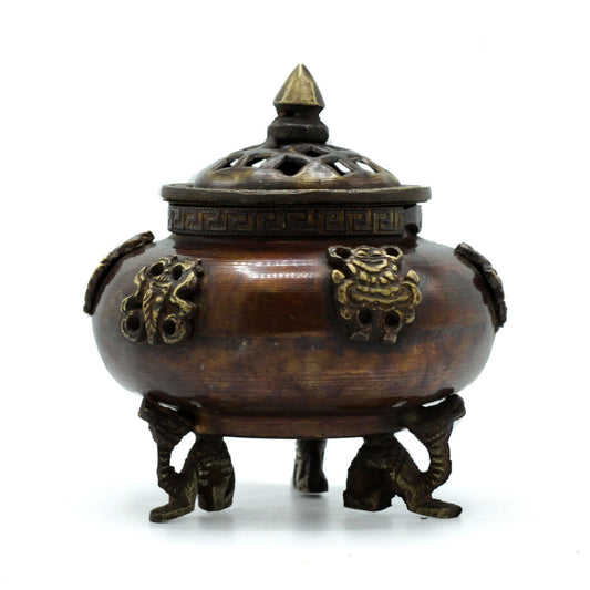 The Brass Tibetan Incense Burner – Six Symbols Standing Pot brings sacred energy, protection, and balance into any space. Handcrafted in India from high-quality brass, this standing pot features six auspicious symbols representing good fortune, health, prosperity, longevity, peace, and harmony.
Supported by intricately designed dragon feet — a traditional Tibetan symbol of strength and protection — this burner combines spiritual significance with artistic elegance. As incense burns, smoke rises gracefully,