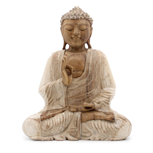 The turning of the Wheel of Dharma is the gesture of wisdom shared, a blessing that flows without beginning or end.
This 30cm Buddha statue is hand-carved from suar wood and finished with a soft whitewash effect, giving it an aged, timeless beauty that evokes the serenity of temple carvings. The gentle white tones highlight the details of the robe, the calm features of the face, and the sacred posture of the hands.
The Buddha is depicted in the Dharmachakra Mudra, the Gesture of Teaching Transmission. Wit