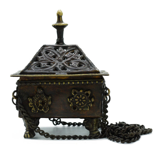 Sacred smoke has always been a bridge between the seen and unseen, a prayer rising on the breath of fire. This Brass Tibetan Hanging Incense Burner – Eight Symbols Square Pot carries that tradition with beauty and reverence.
Handcrafted in India, the square brass pot is engraved with the Eight Auspicious Symbols, each blessing the space with fortune, health, prosperity, longevity, harmony, victory, and fulfillment. Suspended on a chain, this sacred vessel allows incense smoke to flow gently downward, creat