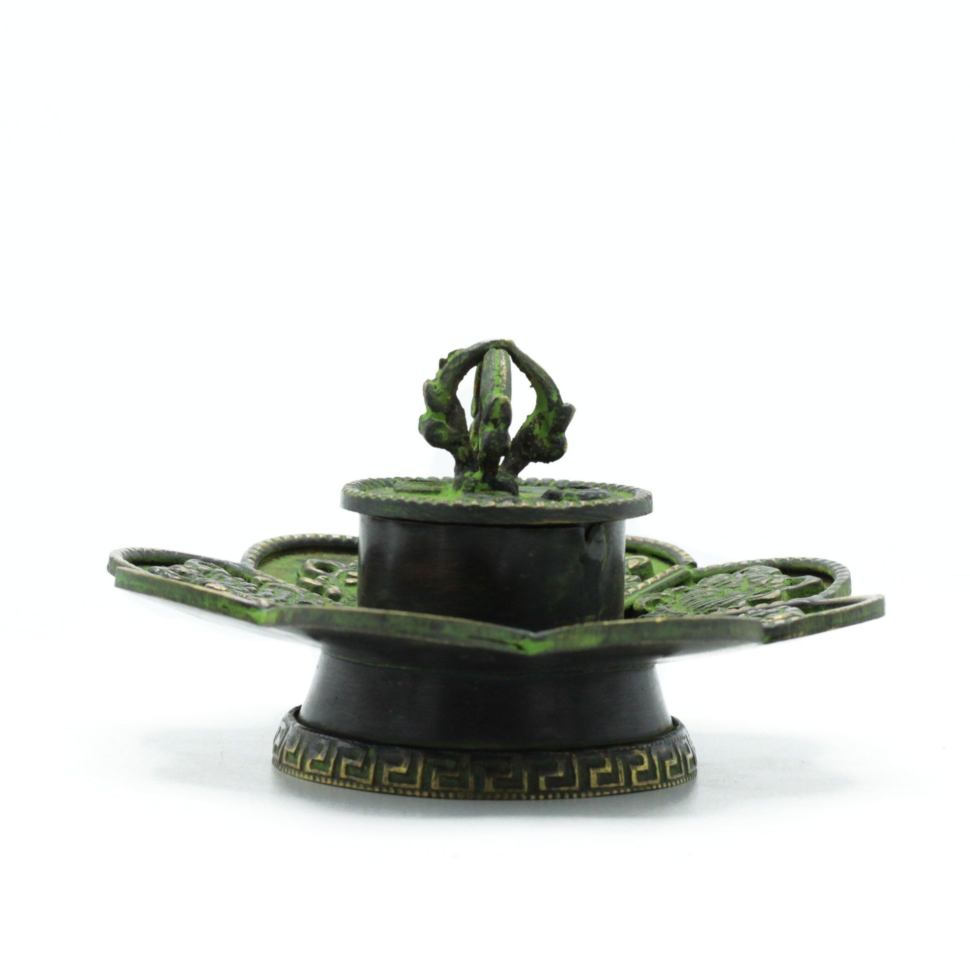 The Eight Auspicious Symbols have long been honored as sacred signs of harmony, balance, and blessing upon the path of spirit. This Brass Verdigris Tibetan Cone & Incense Holder – Eight Symbols is a vessel of serenity, designed not only as an incense burner but as a channel of spiritual energy.
Handcrafted in India, the flower-shaped base is beautifully engraved with the Eight Sacred Emblems, each carrying its own blessing: good fortune, health, prosperity, longevity, peace, harmony, victory, and spiritual