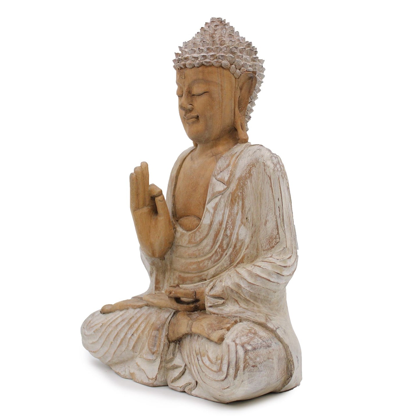 The turning of the Wheel of Dharma is the gesture of wisdom shared, guiding all who seek understanding.
This 40cm Buddha statue is hand-carved from suar wood and finished with a soft whitewash, giving it an elegant, timeless appearance. The subtle white tones emphasize the flowing robes, serene facial features, and sacred hand gestures, reflecting the artisan’s skill and devotion.
The Buddha is depicted in the Dharmachakra Mudra, the Gesture of Teaching Transmission. With both hands raised before the hear