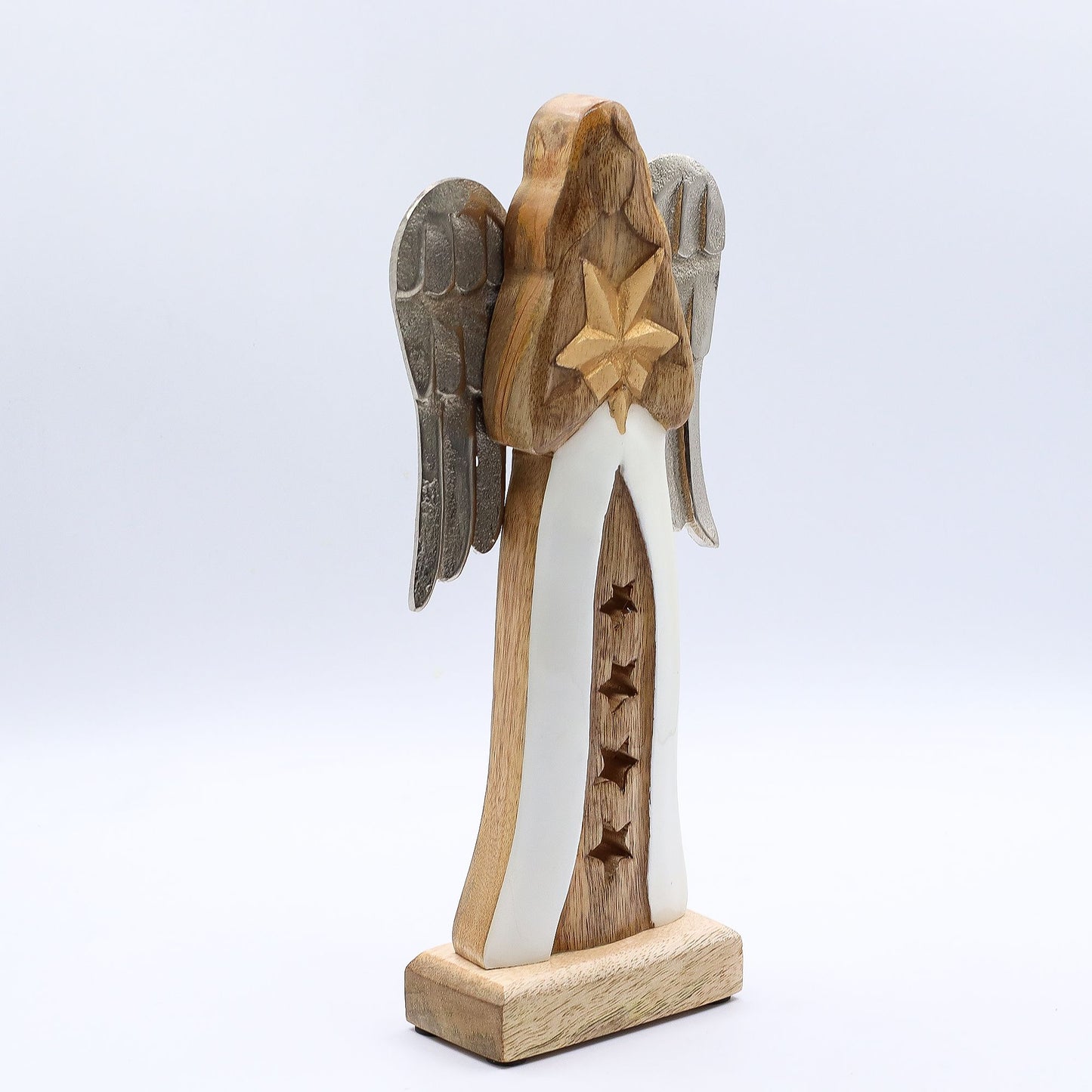 From the heavenly collections of thewitchesgarden, this exquisite Large Mango Wood Star Angel radiates divine serenity and craftsmanship. Hand-carved from rich mango wood, the angel clasps a golden star close to its heart — a sacred symbol of hope, peace, and guiding light.
Its antique-style metal wings glimmer softly against a flowing white enamel robe, adorned with delicate star cut-outs that whisper of celestial realms. Each detail speaks of devotion and artistry, blending natural wood grain, luminous e